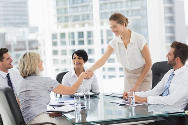 Side view of executives shaking hands during a business meeting in the office.jpeg