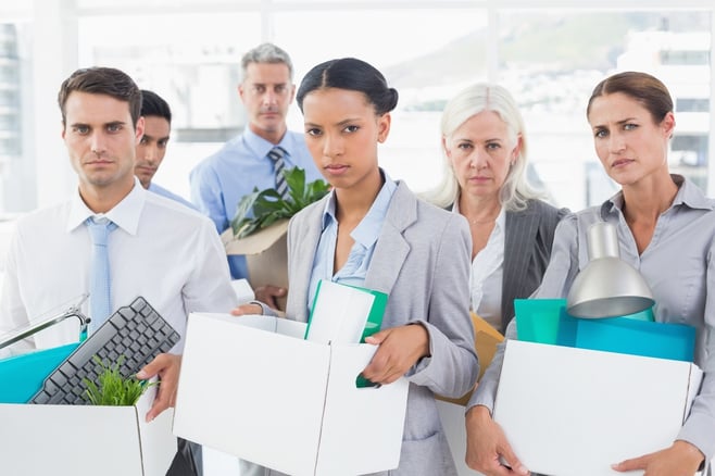 Unhappy fired business people holding box in office.jpeg