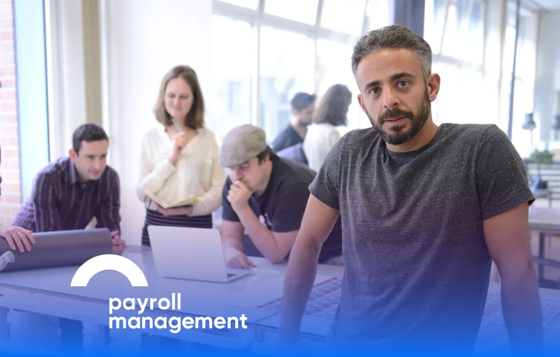 payroll-management-man-leaning-desk
